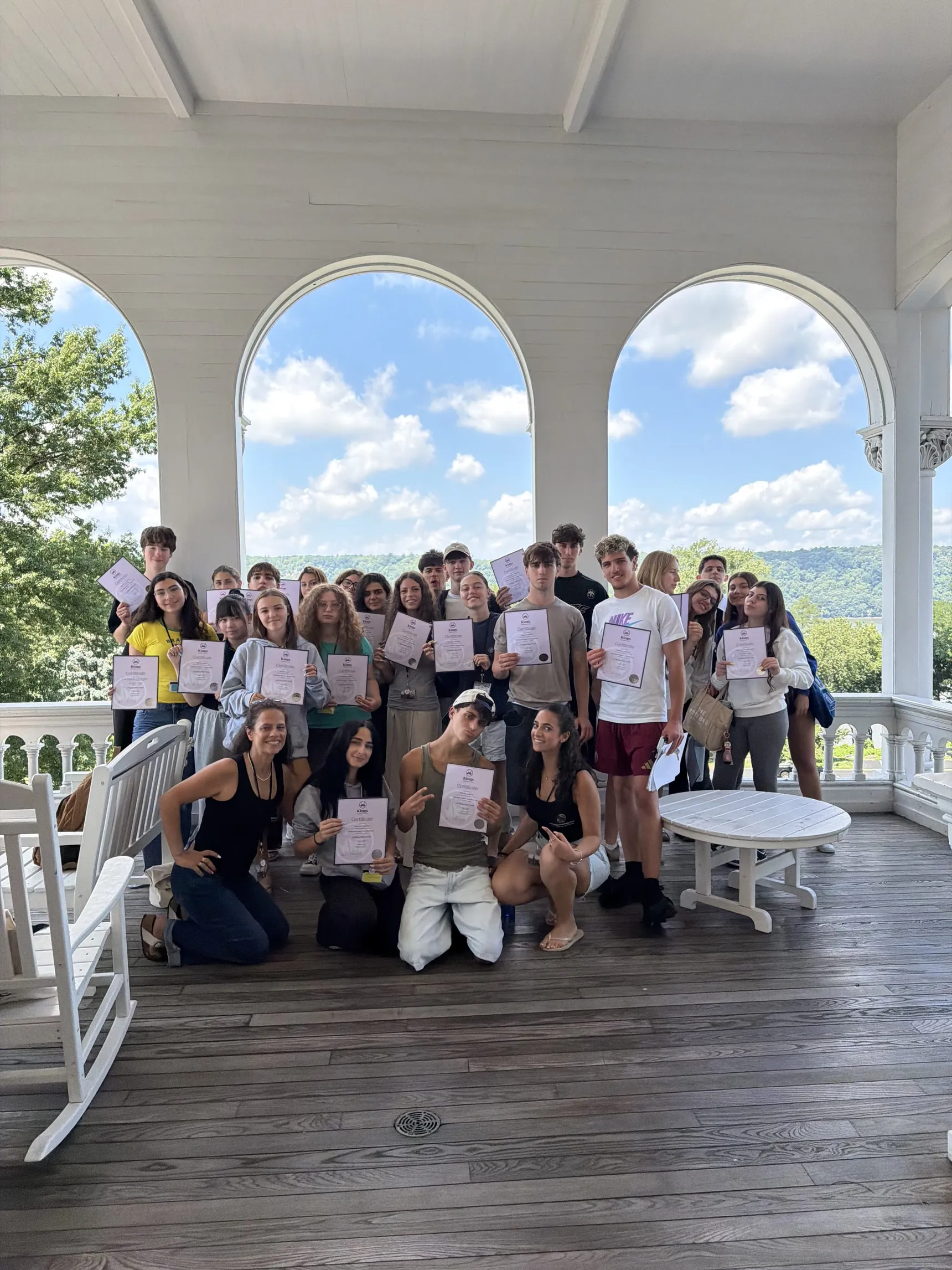 Certificates handed out on the campus porch
