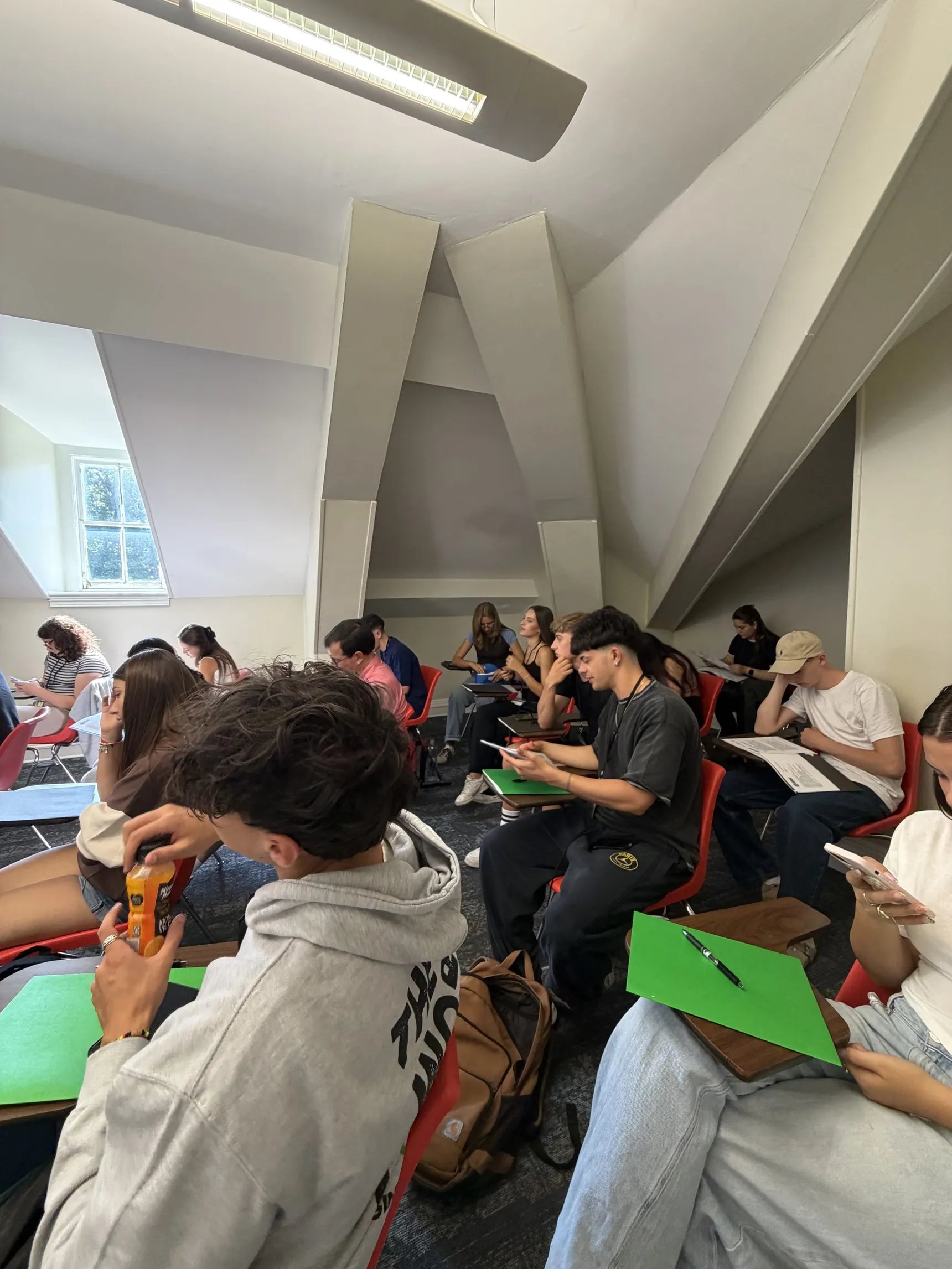 Students in the classroom with their course folders