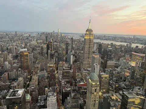 Manhattan at sunset seen from above, with the Empire State Building