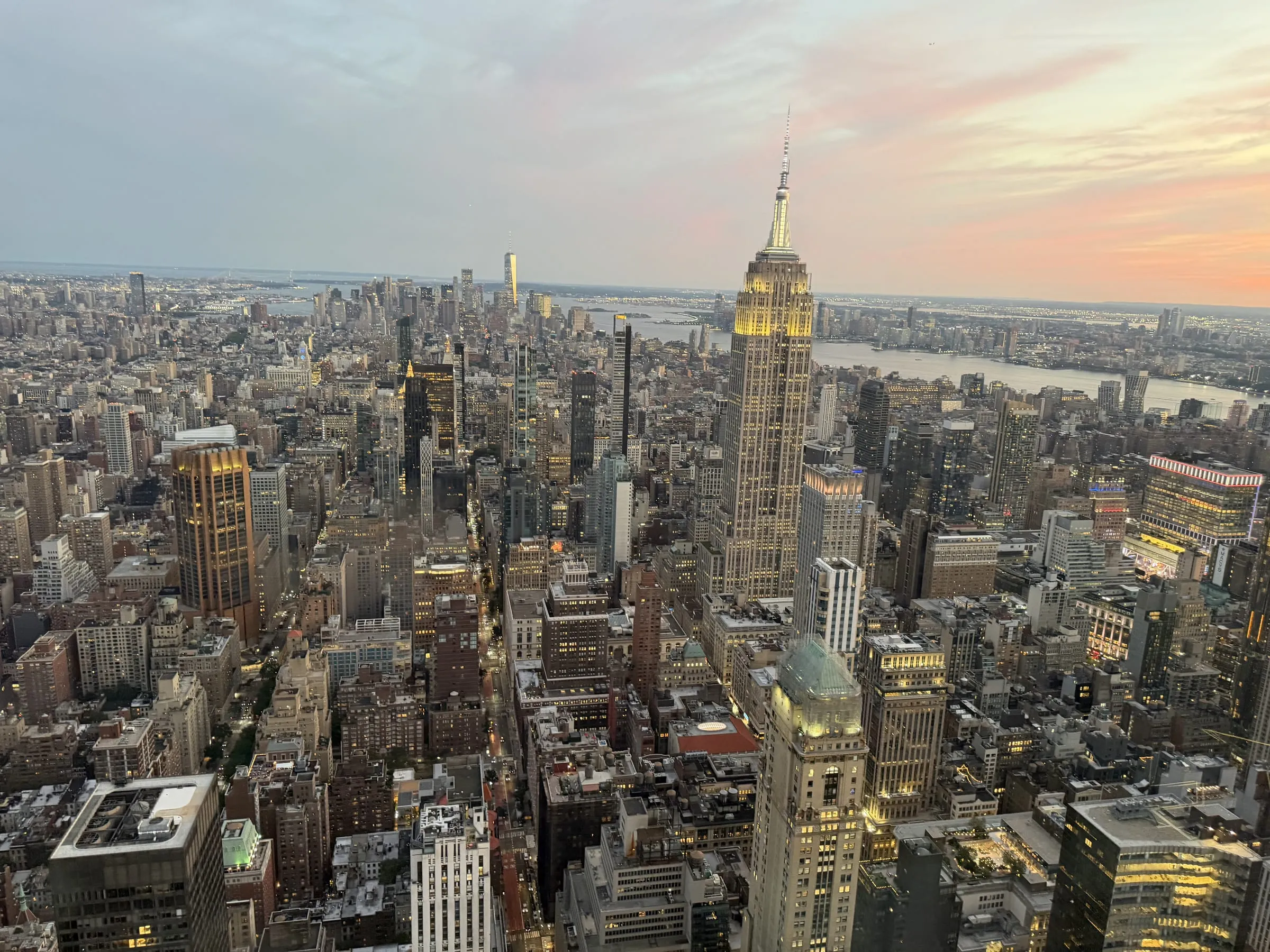 Manhattan at sunset seen from above, with the Empire State Building